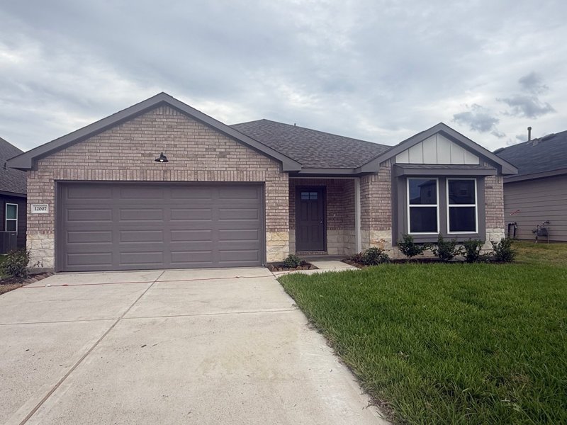 Front exterior of an Alta Homes residence at 12007 Curlin Drive in Lexington Heights in Willis.